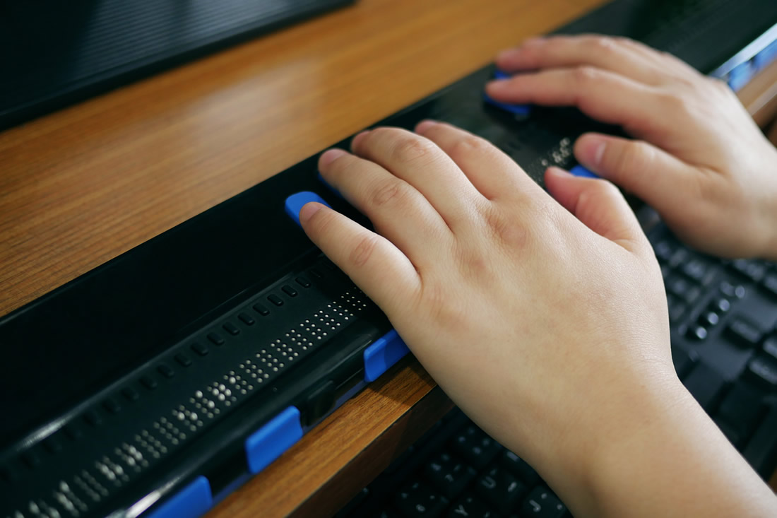 A person using a braille display. Photo