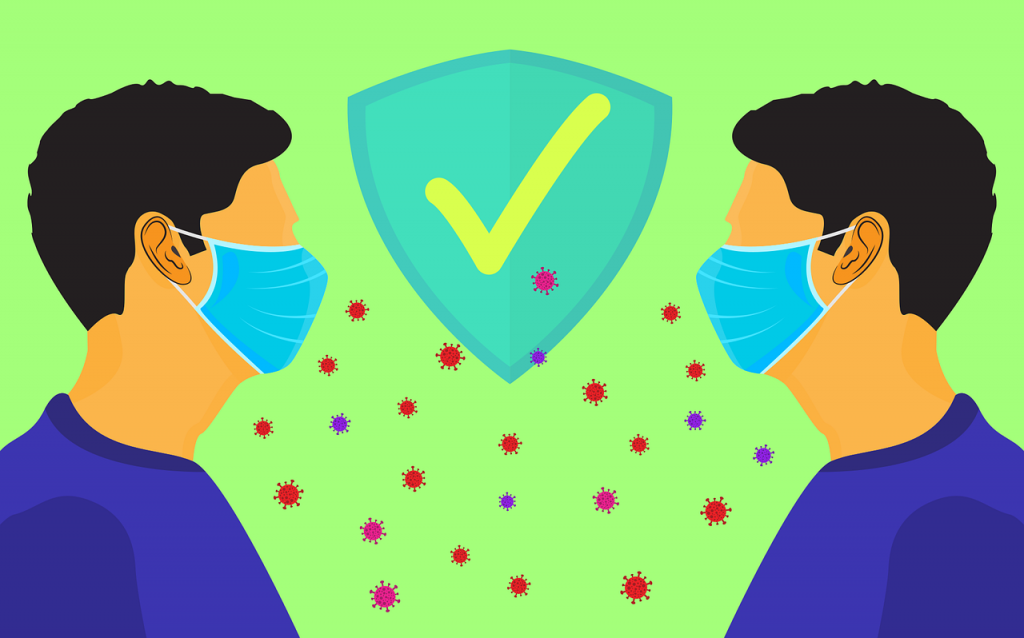 ilustrácia, dvaja muži oproti sebe, v rúškach, v strede naznačený symbol súhlasu, za dodržiavaný rozostup. Medzi nimi sú roztrúsené aj mikročastice vírusu, ale rúška a rozostup ich chránia
