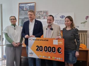 Na fotografii stojí T. Winterová, riaditeľka ÚNSS, vedľa nej I. Kozák, prezident Únie ligových športov a Roman Berger, gen. riaditeľa sp. Niké a Tímea Hóková, podpredsedníčka ÚNSS. Spoločne držia šek na ktorom je čiastka 20 000 E, Pomáhame spoločne, logo spoločnosti Niké a Niké liga a logá futbalových klubov.